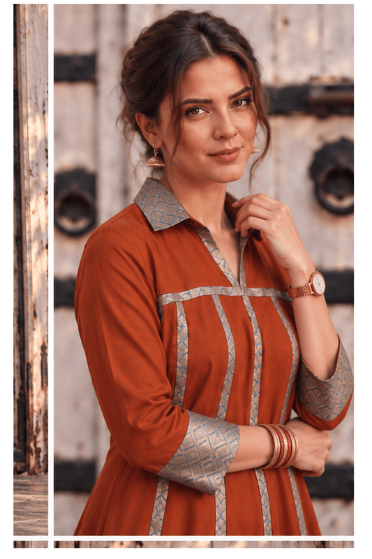 Woman wearing Zinniars Mannat rust brocade flare midi dress with patterned trim.