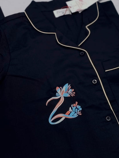 Close-up of Zenith Majestic Black hand-painted cotton satin co-ord set with floral motif.