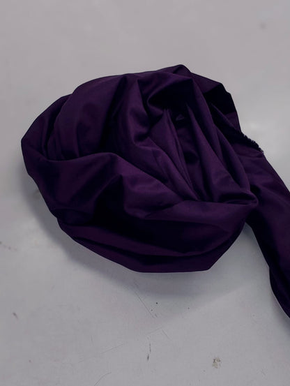 Close-up of folded purple cotton satin fabric from a Zinniars co-ord set.